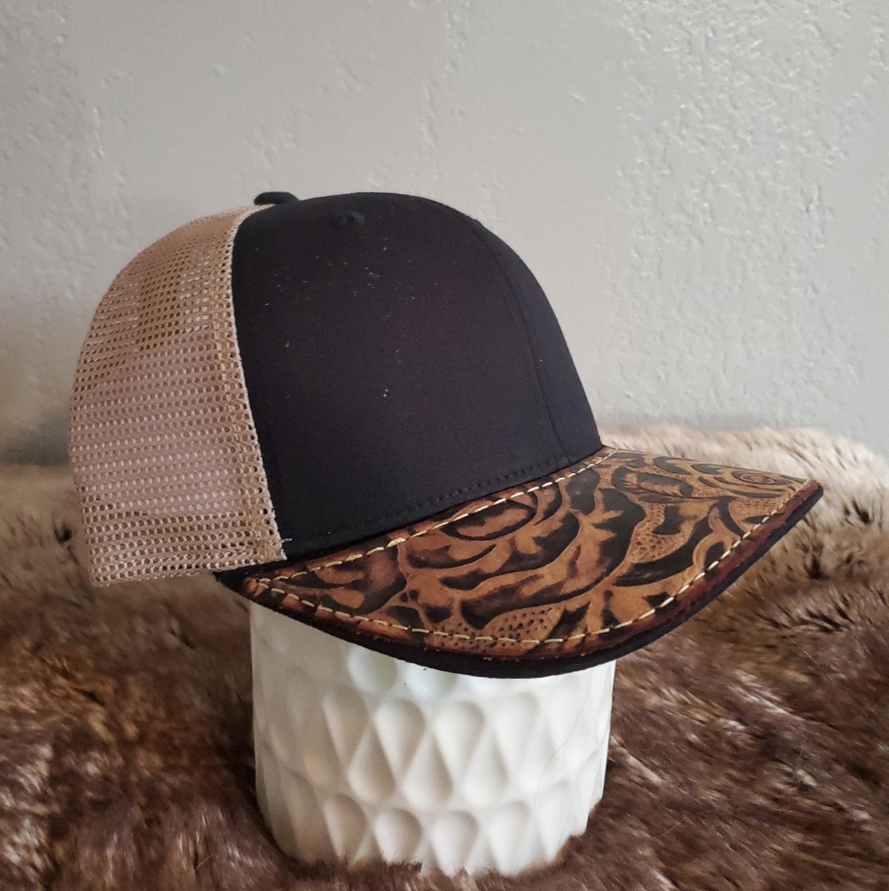 Ball cap with hand-sewn leather patch on brim
